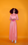 Rent peach pink vintage maxi dress with long sleeves and slinky skirt. Finished with attached long side tie and closes with back zipper