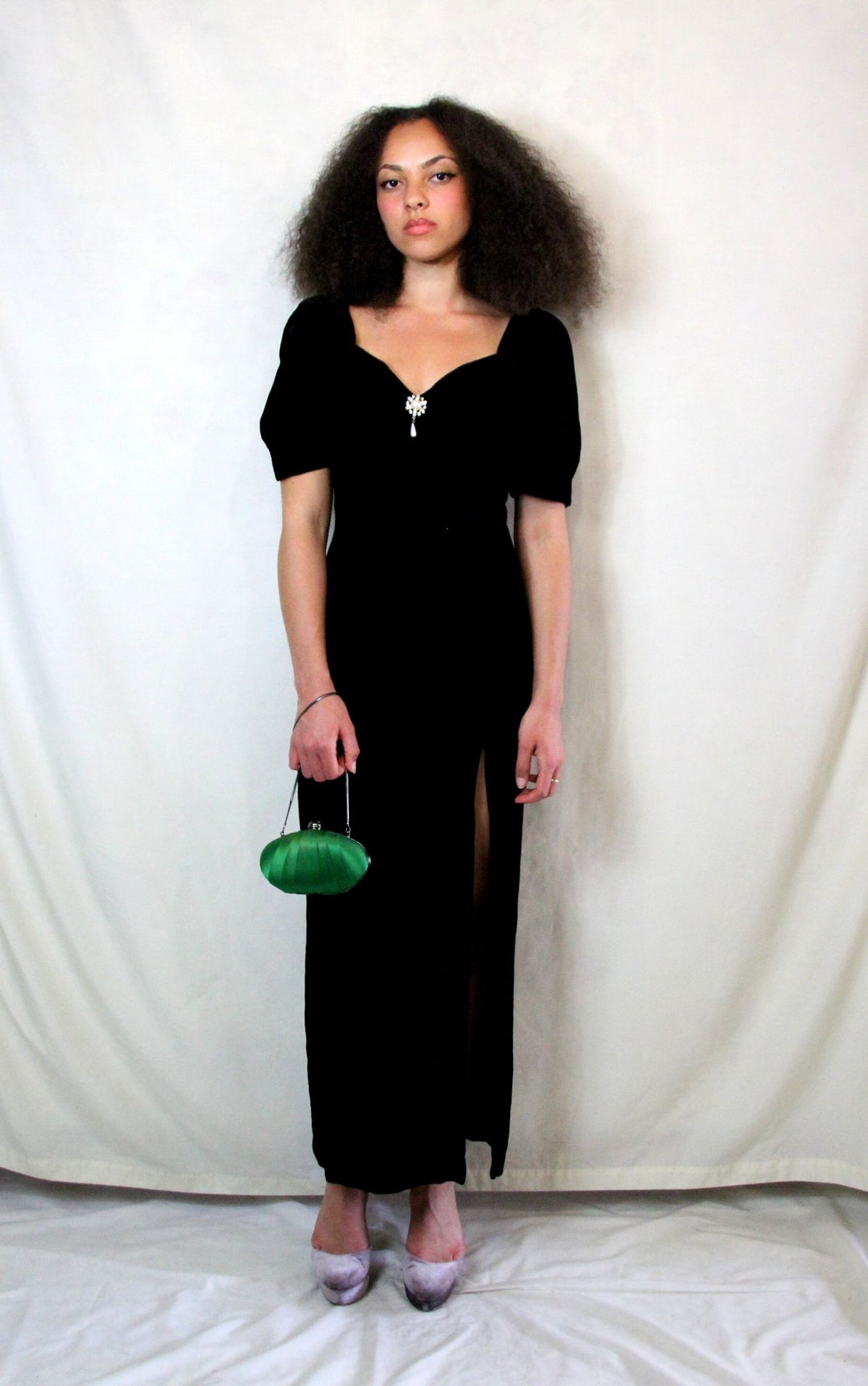 Rent Couture Vintage black maxi dress with sweetheart neckline and structured shoulders. Back zip and subtle split finished off with a delicate and timeless front pearl style brooch