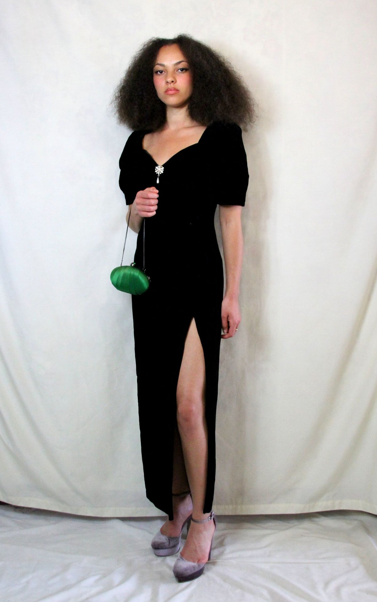 Rent Couture Vintage black maxi dress with sweetheart neckline and structured shoulders. Back zip and subtle split finished off with a delicate and timeless front pearl style brooch