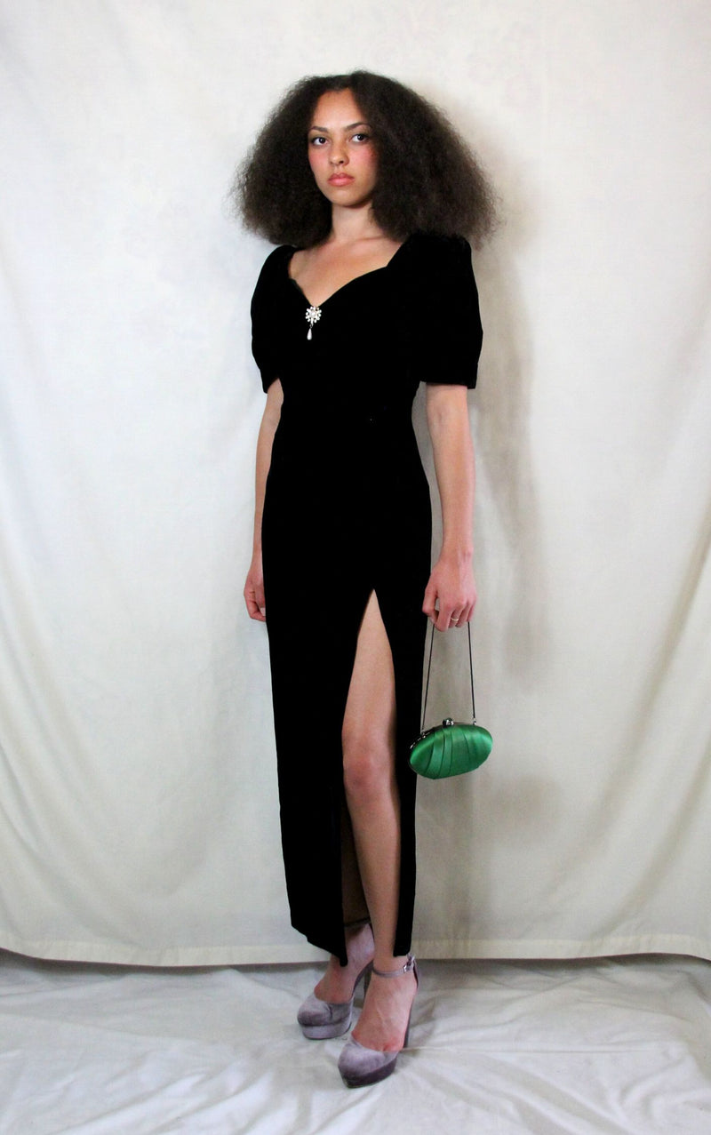 Rent Couture Vintage black maxi dress with sweetheart neckline and structured shoulders. Back zip and subtle split finished off with a delicate and timeless front pearl style brooch