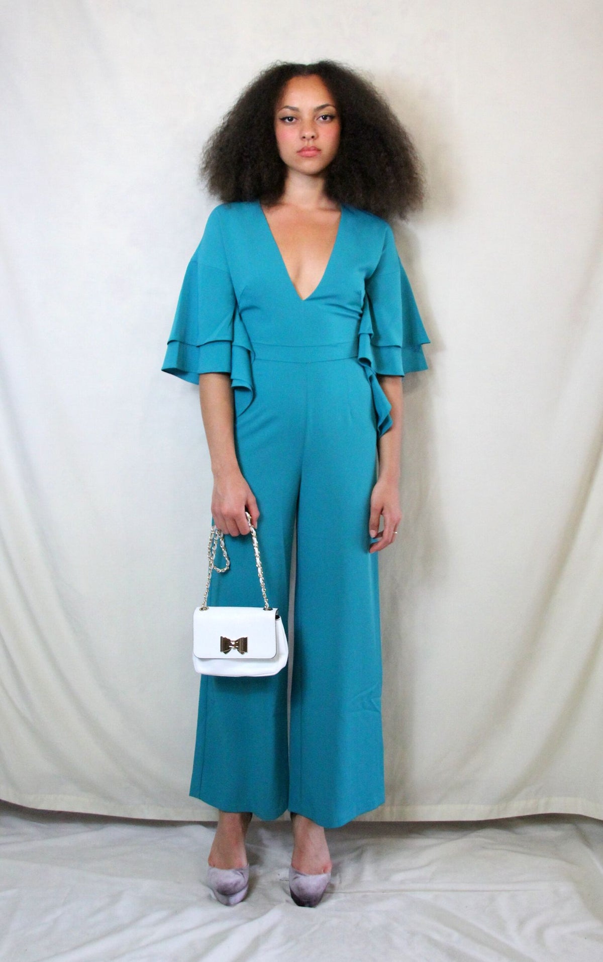 Rent green jumpsuit with plunge neck and back zip to close