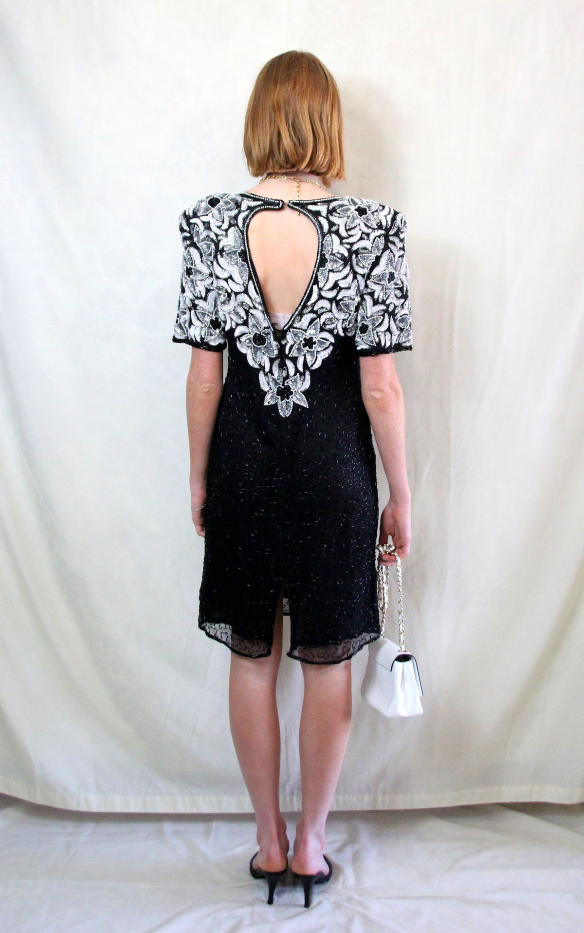 Rent vintage black sequin cocktail dress with shoulder pads and back zip to close