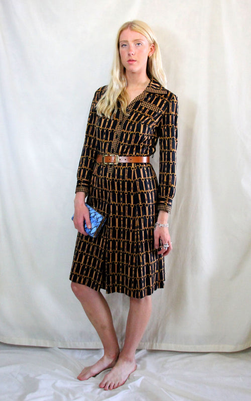 Rent 1970s Vintage dogtooth black, gold and brown chain print shirt dress with button front