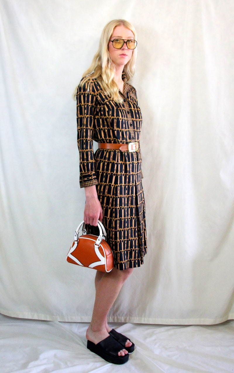 Rent 1970s Vintage dogtooth black, gold and brown chain print shirt dress with button front