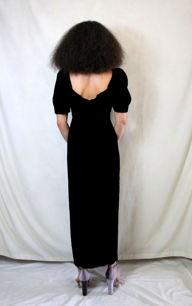Rent Couture Vintage black maxi dress with sweetheart neckline and structured shoulders. Back zip and subtle split finished off with a delicate and timeless front pearl style brooch 