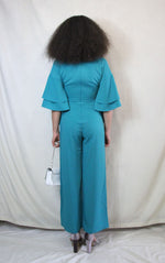 Rent green jumpsuit with plunge neck and back zip to close